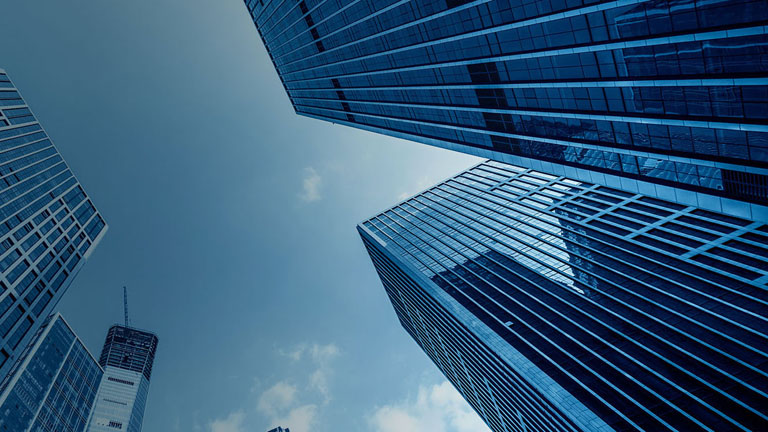 glass office building with cloud background